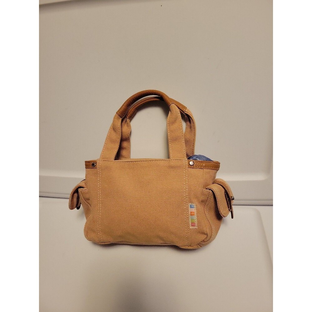 Fossil tan canvas mini bag with side pockets and faux leather trim